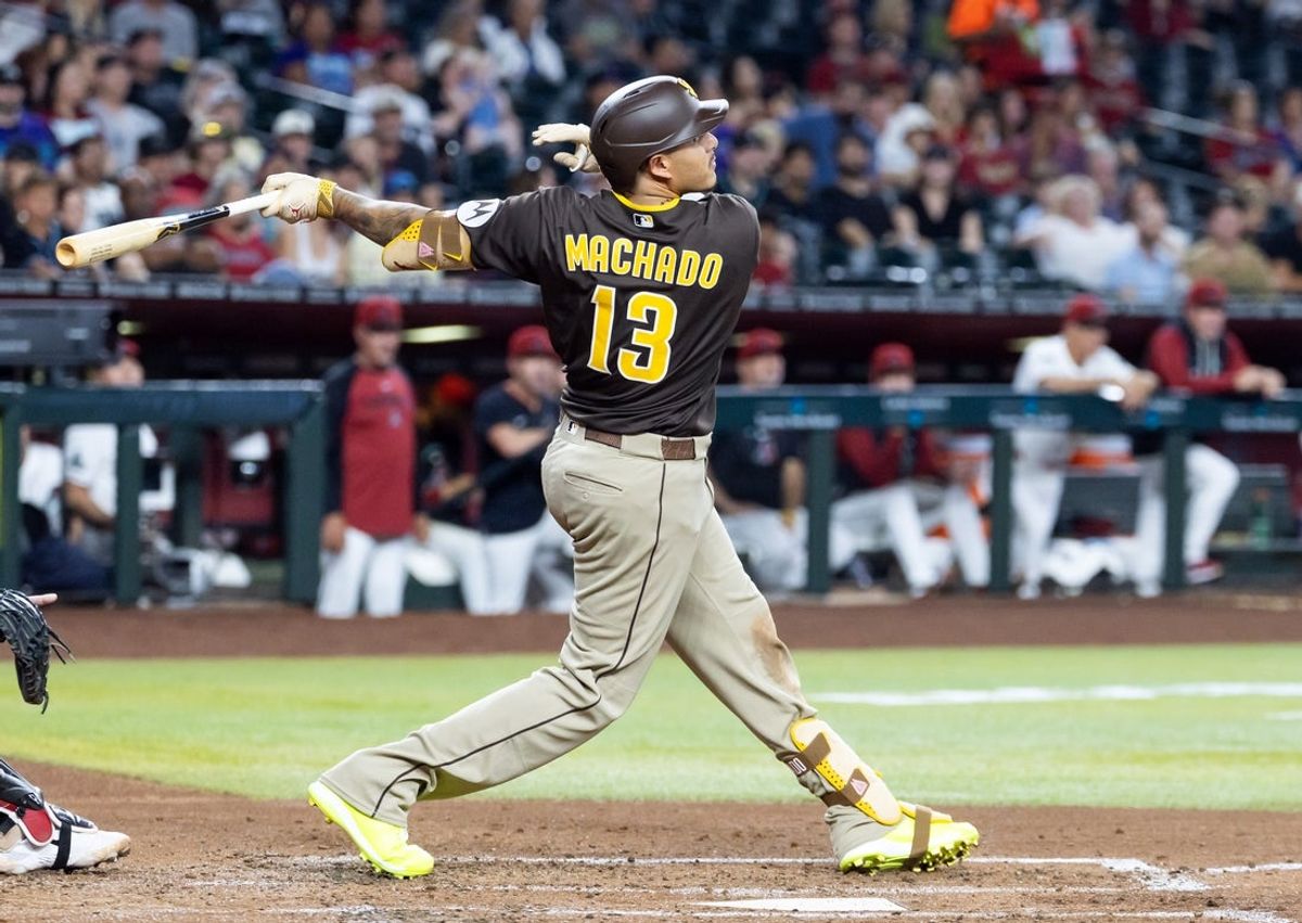 Aug 4, 2026; Phoenix, Arizona, USA; San Diego Padres third baseman Manny Machado hits a two run single in the second inning  against the Arizona Diamondbacks at Chase Field. Mandatory Credit: Mark J. Rebilas-Imagn Images