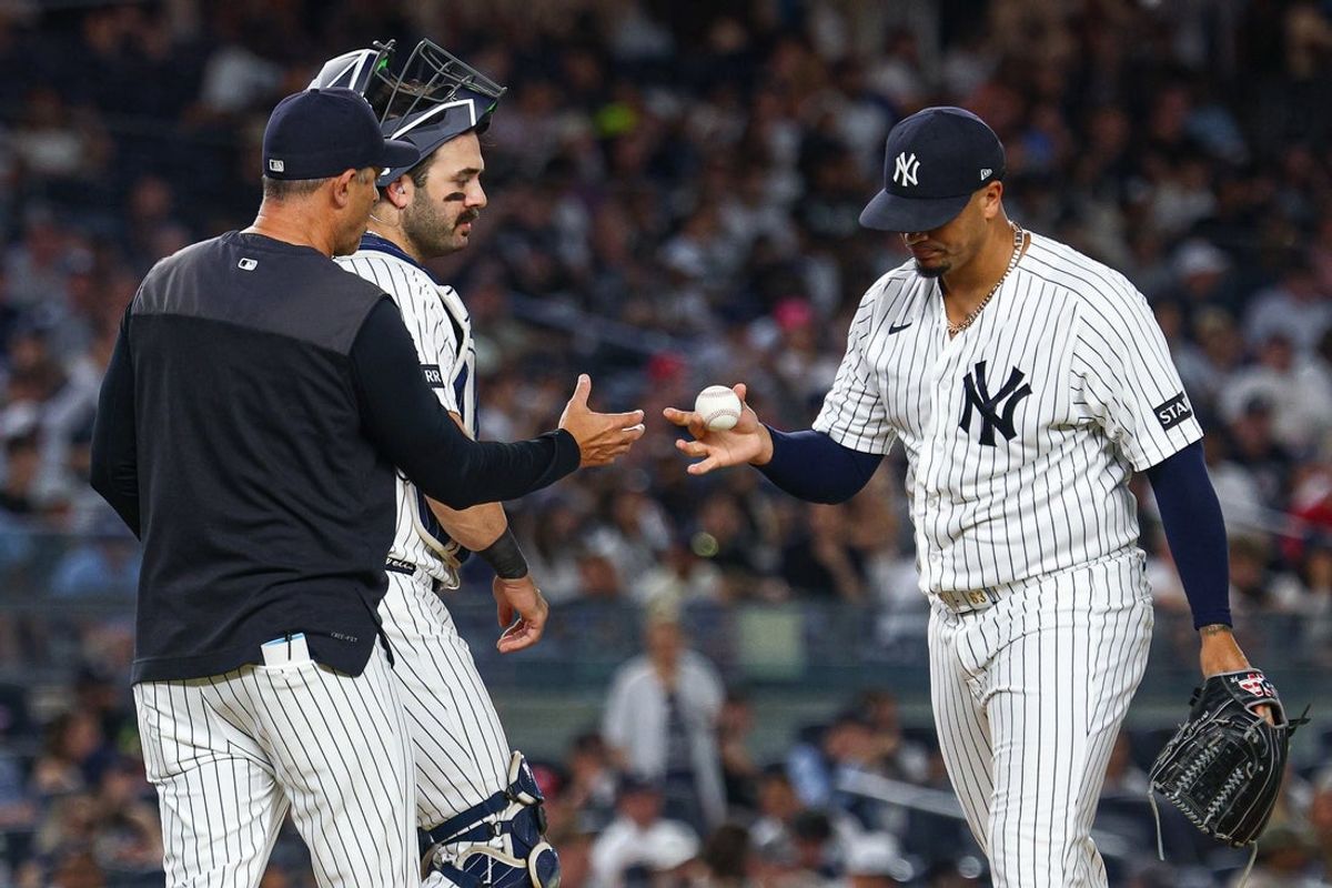 Aug 4, 2026; Bronx, New York, USA;  New York Yankees pitcher Fernando Cruz (63) hands the ball to manager Aaron Boone (17) after being taken out of the game during the seventh inning against the St. Louis Cardinals at Yankee Stadium. Mandatory Credit: Vincent Carchietta-Imagn Images