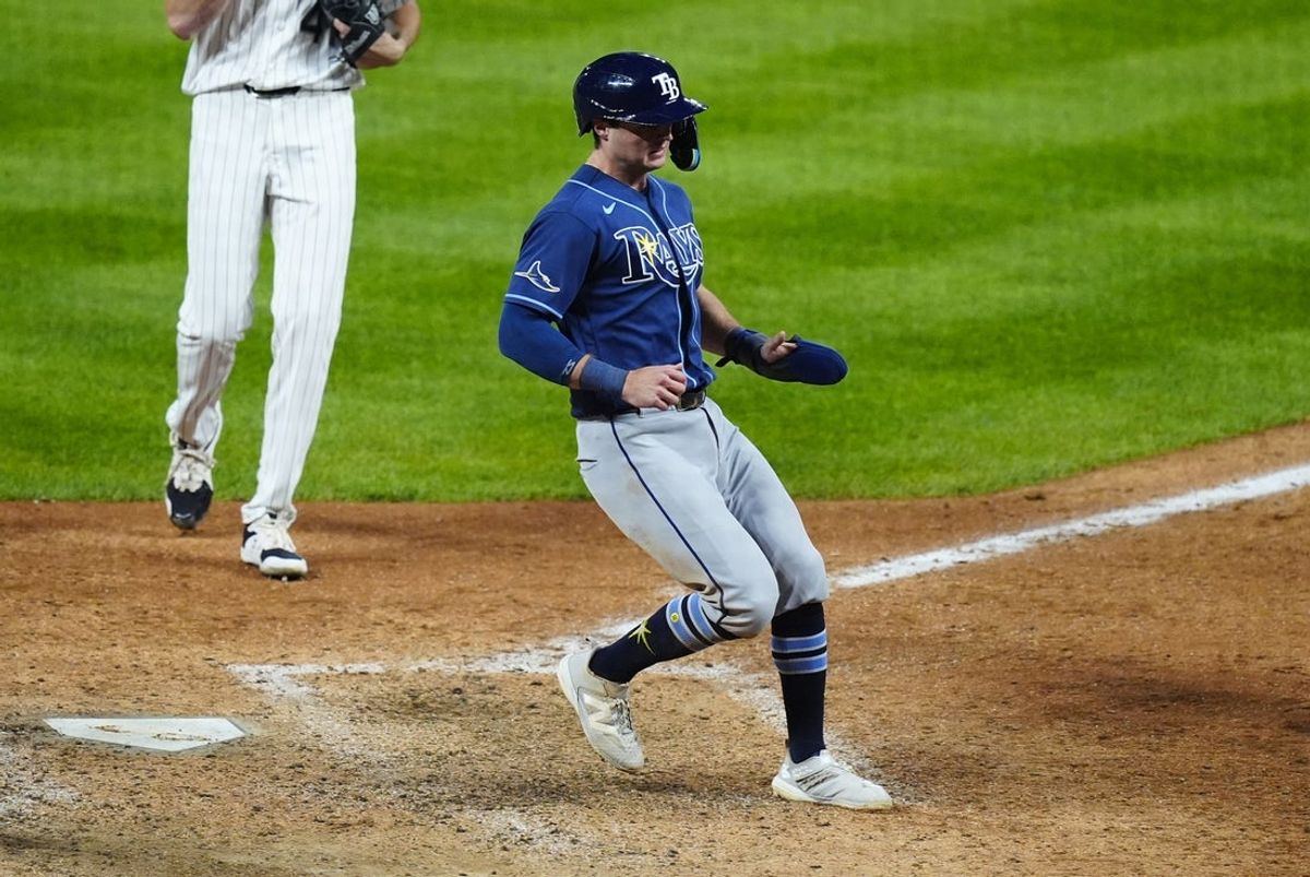 Aug 4, 2026; Denver, Colorado, USA; Tampa Bay Rays ghost runner Ben Williamson (15) scores on wild pitch in the eleventh inning against the Colorado Rockies at Coors Field. Mandatory Credit: Ron Chenoy-Imagn Images