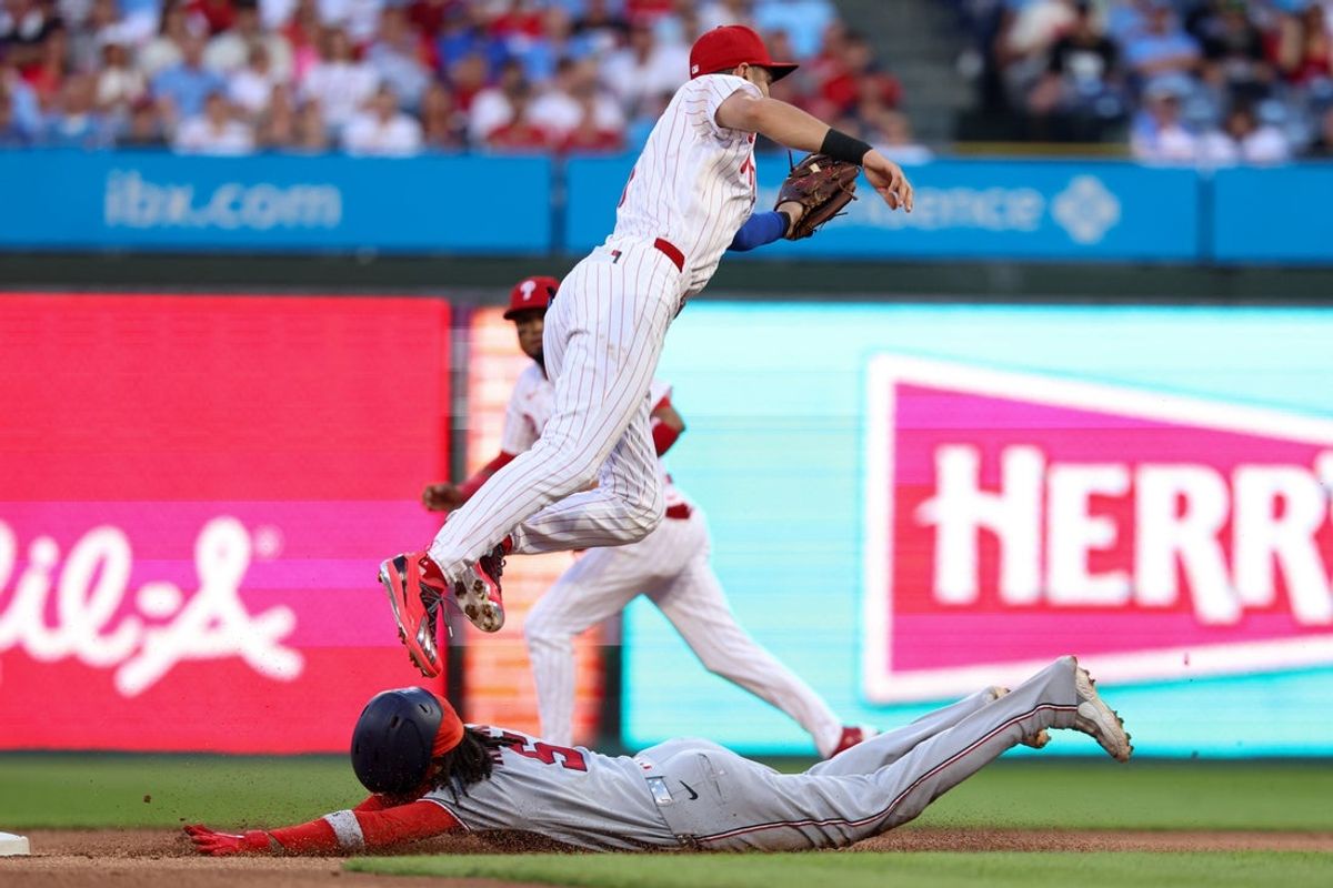 Aug 5, 2026; Philadelphia, Pennsylvania, USA; Washington Nationals shortstop CJ Abrams (5) steals second base past Philadelphia Phillies shortstop Trea Turner (7) during the first inning at Citizens Bank Park. Mandatory Credit: Bill Streicher-Imagn Images