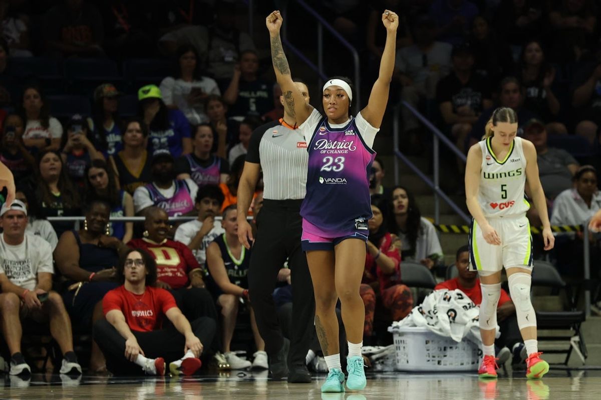 Aug 5, 2026; Washington, District of Columbia, USA; Washington Mystics guard Cotie McMahon (23) celebrates after the final buzzer as Dallas Wings guard Paige Bueckers (5) walks off the floor at CareFirst Arena. Mandatory Credit: Geoff Burke-Imagn Images