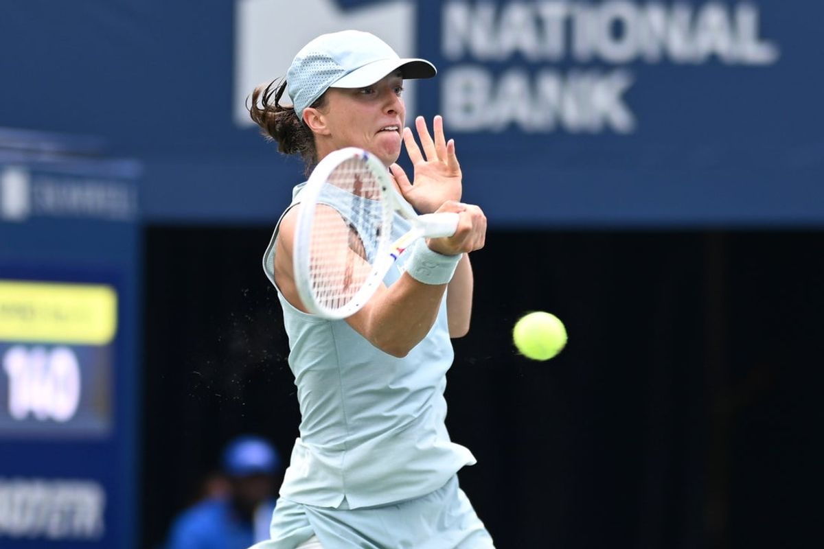Aug 6, 2026; Toronto, Ontario, Canada;  Iga Swiatek (POL) plays a shot against Viktorija Golubic (SUI) during fourth round play at Sobeys Stadium. Mandatory Credit: Dan Hamilton-Imagn Images