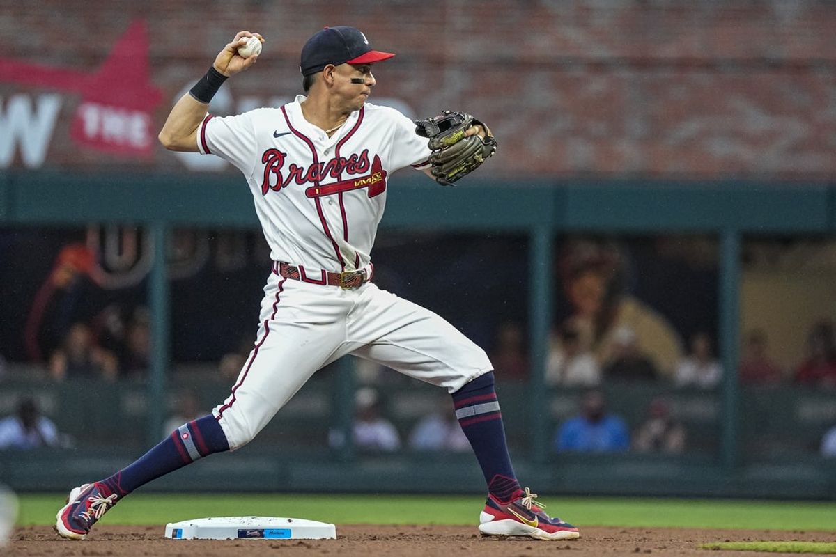 Aug 6, 2026; Cumberland, Georgia, USA; Atlanta Braves second baseman Mauricio Dubon (14) turns to throw for a double play against the Miami Marlins during the second inning at Truist Park. Mandatory Credit: Dale Zanine-Imagn Images