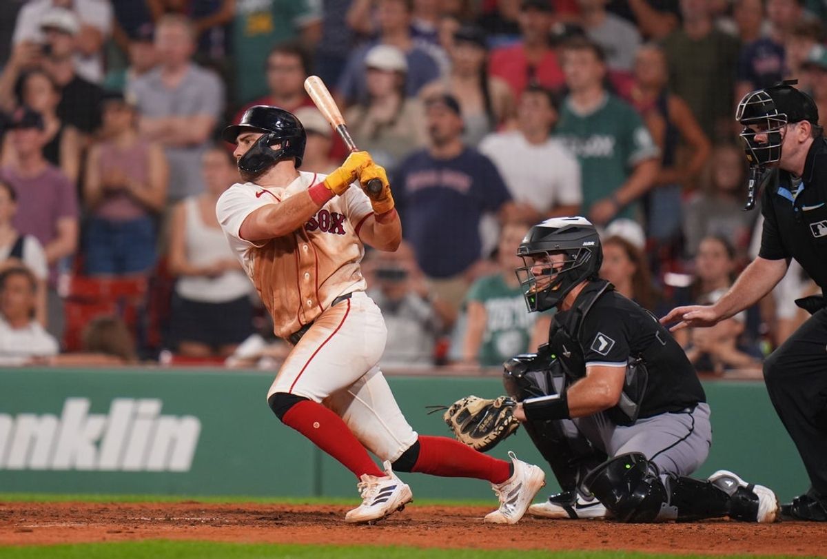 Aug 6, 2026; Boston, Massachusetts, USA; Boston Red Sox third baseman Caleb Durbin (5) hits a single to center field to win the game against the Chicago White Sox in the thirteenth inning at Fenway Park. Mandatory Credit: David Butler II-Imagn Images