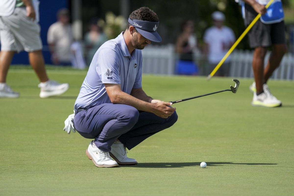 Aug 7, 2026; Greensboro, North Carolina, USA; Beau Hossler lines up his putt on the 18th green during the second round of the Wyndham Championship golf tournament. Mandatory Credit: Jim Dedmon-Imagn Images