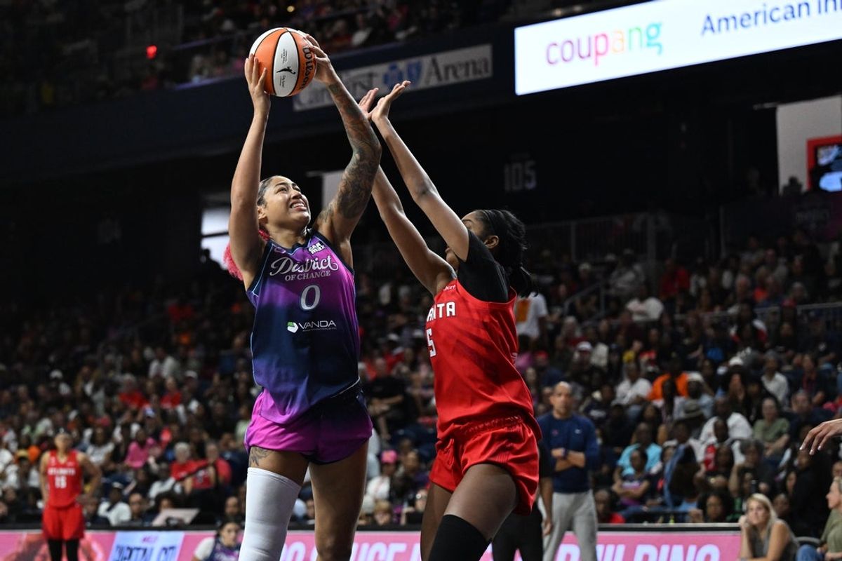 Aug 7, 2026; Washington, District of Columbia, USA; Washington Mystics center Shakira Austin (0) shoots over Atlanta Dream forward Angel Reese (5) during the second half at CareFirst Arena. Mandatory Credit: Brad Mills-Imagn Images