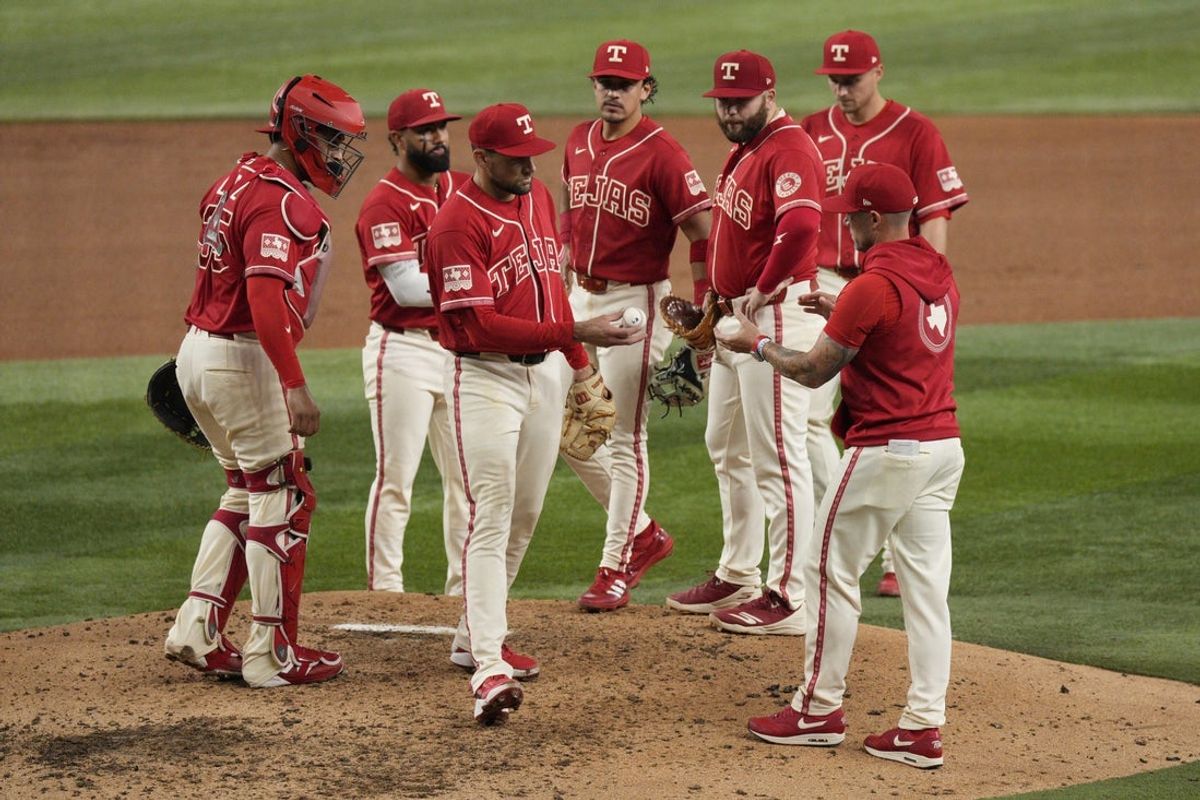 Aug 7, 2026; Arlington, Texas, USA;  Texas Rangers pitcher Nathan Eovaldi (17) hands the ball to manager Skip Schumaker (55) as he is taken out of the game during the sixth inning against the Baltimore Orioles at Globe Life Field. Mandatory Credit: Raymond Carlin III-Imagn Images
