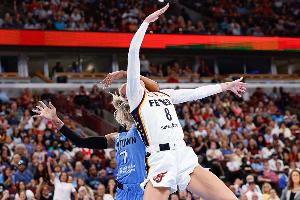 Aug 8, 2026; Chicago, Illinois, USA; Indiana Fever guard Sophie Cunningham (8) is fouled by Chicago Sky guard DiJonai Carrington (7) as she drives to the basket during the first half at United Center. Mandatory Credit: Kamil Krzaczynski-Imagn Images