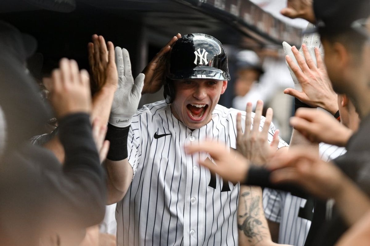 Aug 8, 2026; Bronx, New York, USA; New York Yankees first baseman Ben Rice (22) is greeted by teammates in the dugout after hitting a solo home run against the Atlanta Braves during the eighth inning at Yankee Stadium. Mandatory Credit: John Jones-Imagn Images