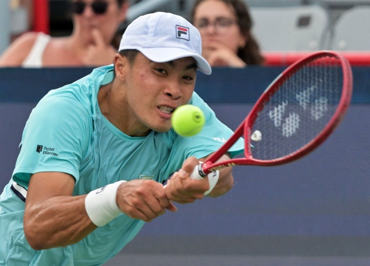 Aug 8, 2026; Montreal, QC, Canada; Brandon Nakashima (USA) hits a backhand against Arthur Rinderknech (FRA) during round of sixteen play at IGA Stadium. Mandatory Credit: Eric Bolte-Imagn Images