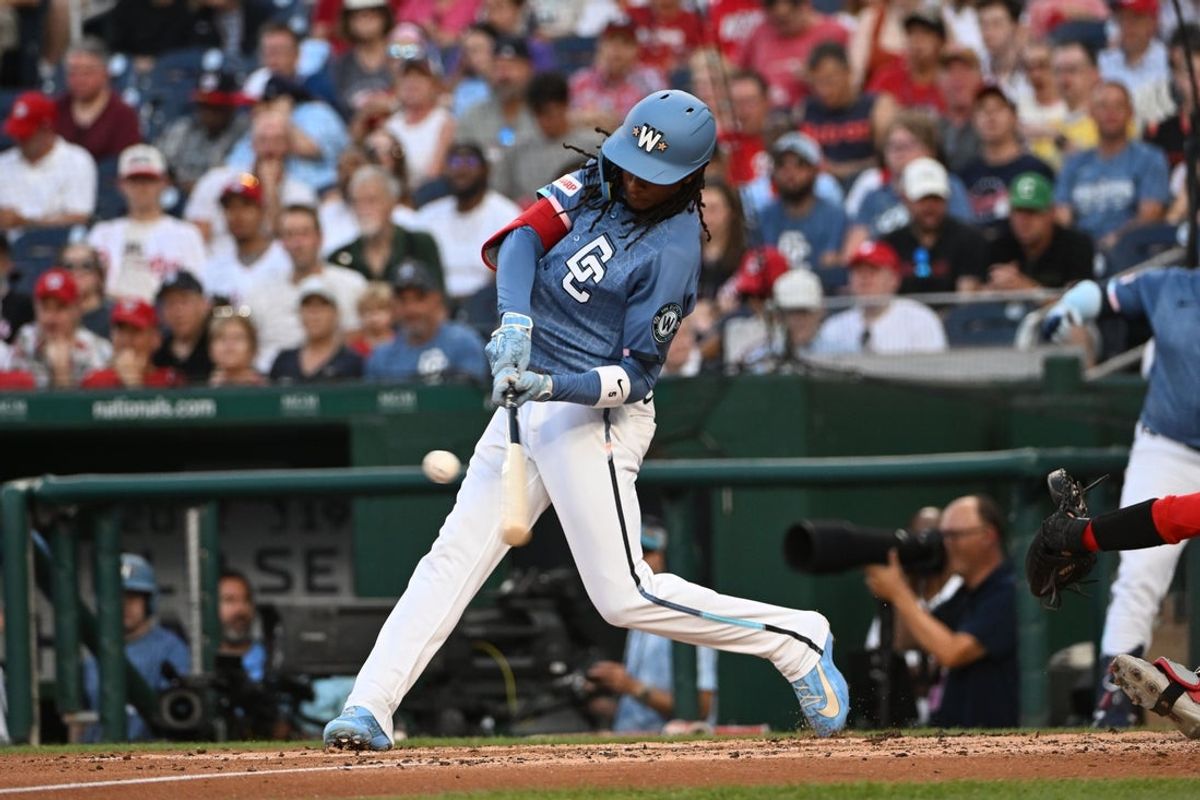 Aug 8, 2026; Washington, District of Columbia, USA; Washington Nationals shortstop CJ Abrams (5) doubles against the Cincinnati Reds during the third inning at Nationals Park. Mandatory Credit: Brad Mills-Imagn Images