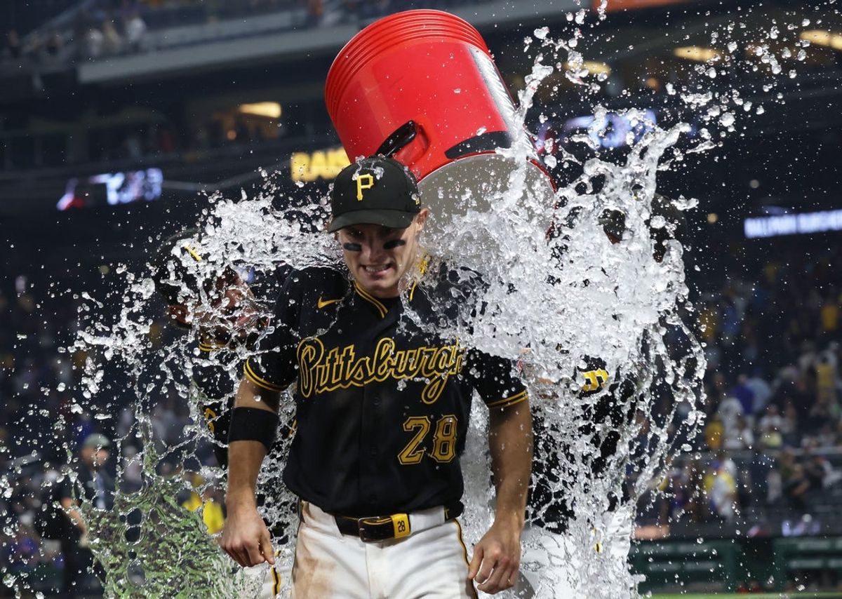 Aug 8, 2026; Pittsburgh, Pennsylvania, USA;  Pittsburgh Pirates center fielder Jake Mangum (28) is doused with water after a 9-0 shutout of the New York Mets at PNC Park. Mandatory Credit: Charles LeClaire-Imagn Images