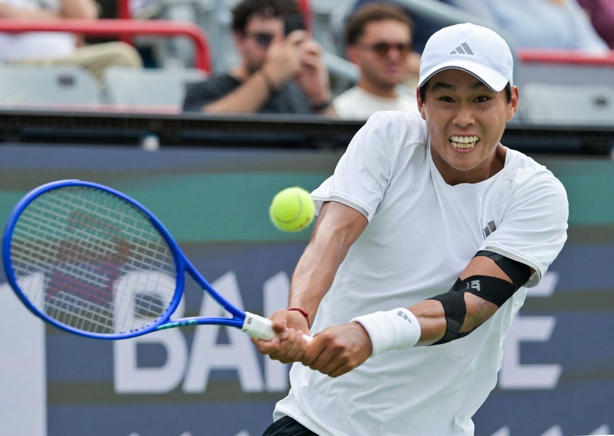 Aug 9, 2026; Montreal, QC, Canada; Learner Tien (USA) hits a backhand against Thiago Agustin Tirante (ARG) during round of sixteen play at IGA Stadium. Mandatory Credit: Eric Bolte-Imagn Images