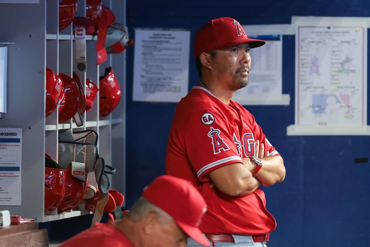 Aug 9, 2026; Miami, Florida, USA; Los Angeles Angels manager Kurt Suzuki (8) watches from inside the dugout against the Miami Marlins during the fifth inning at loanDepot Park. Mandatory Credit: Sam Navarro-Imagn Images