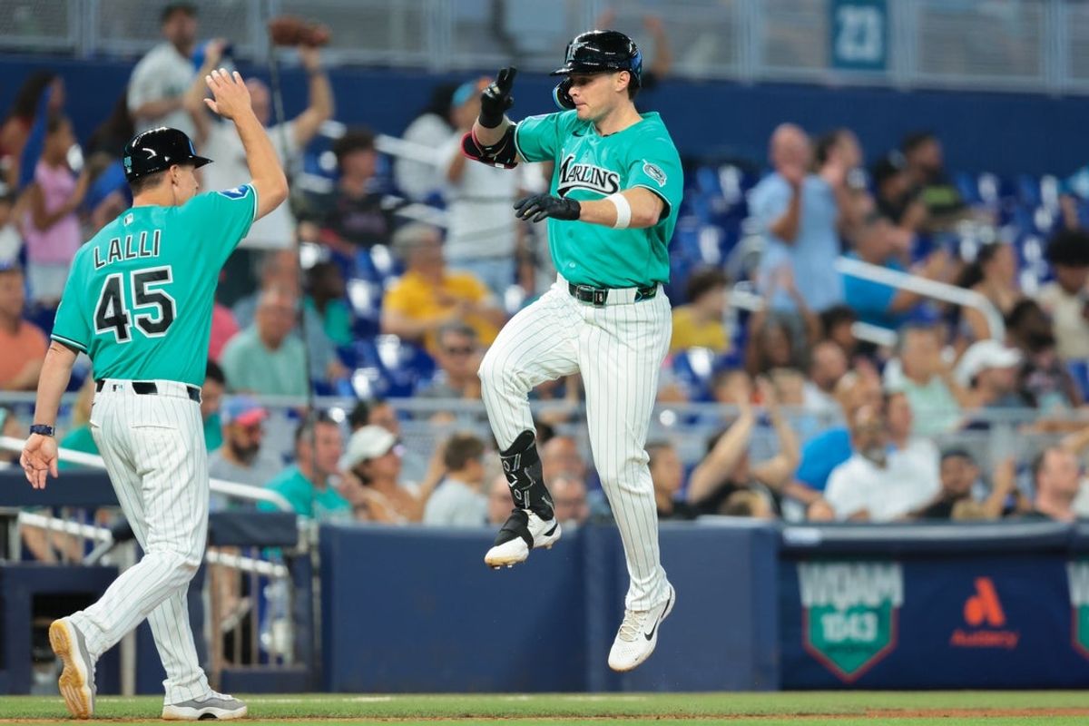 Aug 9, 2026; Miami, Florida, USA; Miami Marlins designated hitter Griffin Conine (18) celebrates with third base coach Blake Lalli (45) after hitting a two-run home run against the Los Angeles Angels during the fifth inning at loanDepot Park. Mandatory Credit: Sam Navarro-Imagn Images
