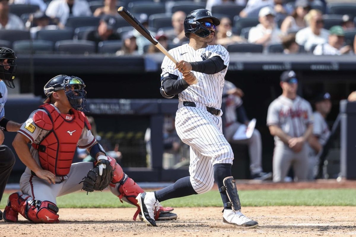 Aug 9, 2026; Bronx, New York, USA;  New York Yankees center fielder Trent Grisham (12) hits a solo home run in the eighth inning against the Atlanta Braves at Yankee Stadium. Mandatory Credit: Wendell Cruz-Imagn Images