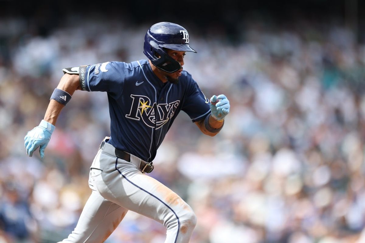 Aug 9, 2026; Seattle, Washington, USA; Tampa Bay Rays left fielder Chandler Simpson (14) runs towards first base after hitting a single against the Seattle Mariners during the eighth inning at T-Mobile Park. Mandatory Credit: Richard Dizon-Imagn Images