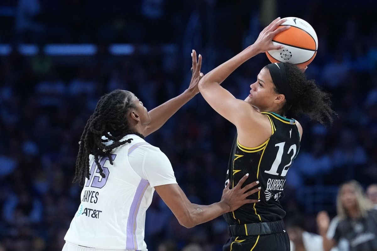 Aug 9, 2026; Los Angeles, California, USA; LA Sparks guard Rae Burrell (12) is defended by Golden State Valkyries guard Tiffany Hayes (15) in the first half at Crypto.com Arena. Mandatory Credit: Kirby Lee-Imagn Images