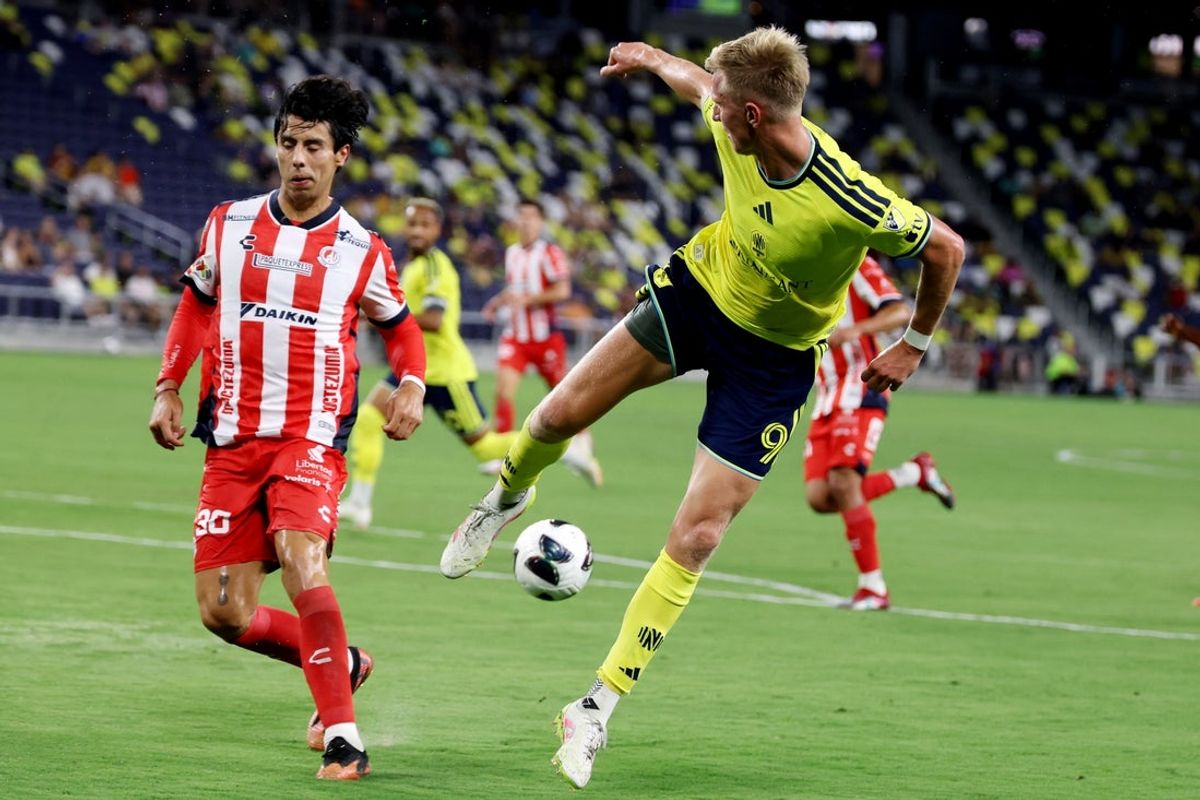 Aug 9, 2026; Nashville, TN, USA; Nashville SC forward Sam Surridge (9) passes the ball behind Atlético de San Luis defender Benjamín Galindo (30) during the second half of their Leagues Cup Phase One match at GEODIS Park. Mandatory Credit: Alan Poizner-Imagn Images