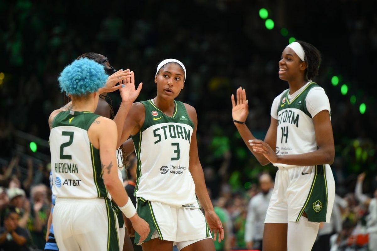 Aug 10, 2026; Seattle, Washington, USA; Seattle Storm guard Natisha Hiedeman (2) and forward Taylor Thierry (3) and center Dominique Malonga (14) celebrate defeating the Chicago Sky at Climate Pledge Arena. Mandatory Credit: Steven Bisig-Imagn Images