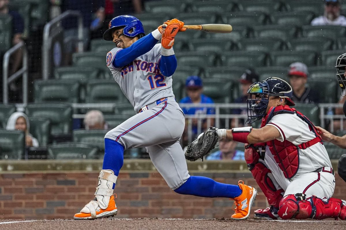 Aug 11, 2026; Cumberland, Georgia, USA; New York Mets shortstop Francisco Lindor (12) hits a single against the Atlanta Braves during the first inning at Truist Park. Mandatory Credit: Dale Zanine-Imagn Images