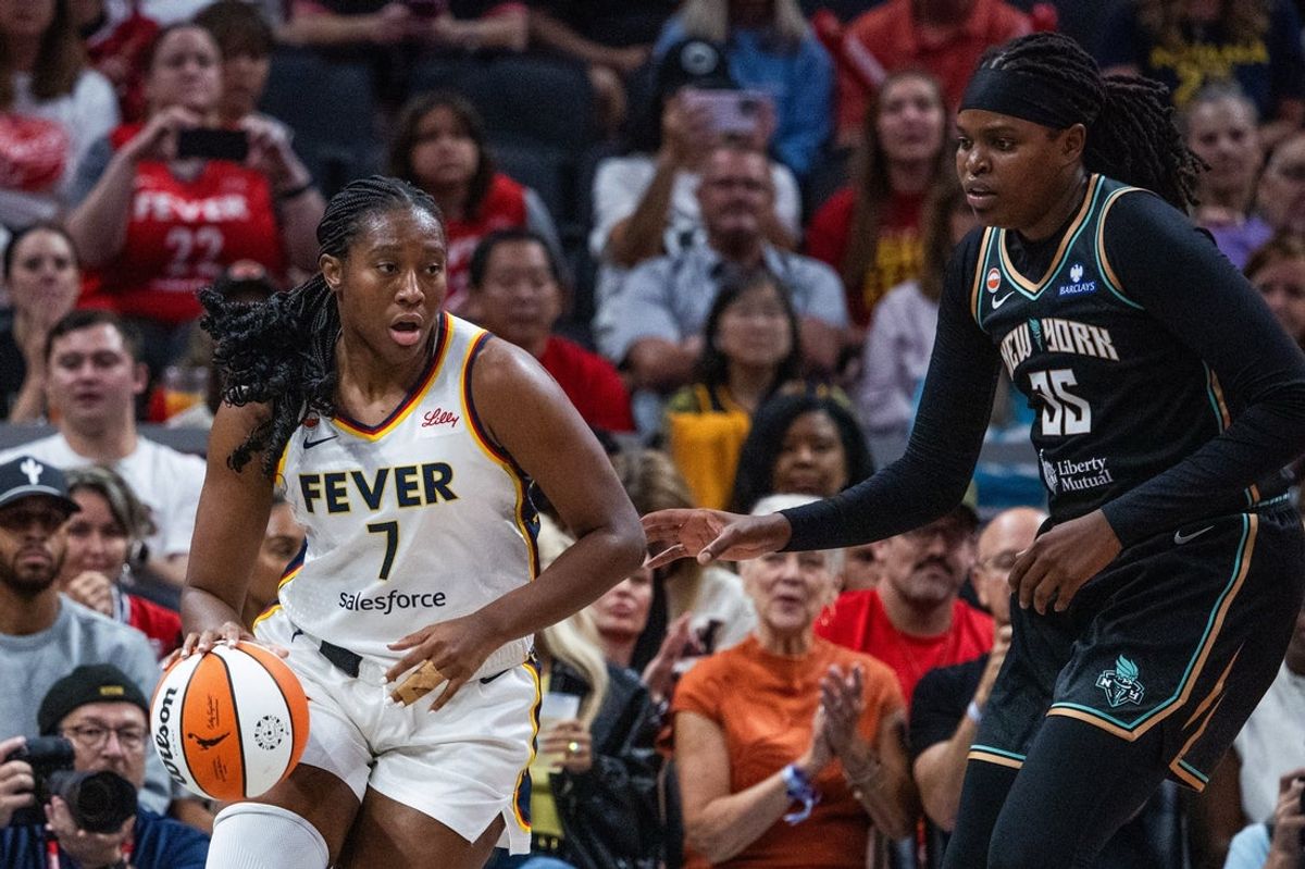 Aug 11, 2026; Indianapolis, Indiana, USA;  Indiana Fever center Aliyah Boston (7) dribbles the ball while New York Liberty center Jonquel Jones (35) defends in the first half at Gainbridge Fieldhouse. Mandatory Credit: Trevor Ruszkowski-Imagn Images