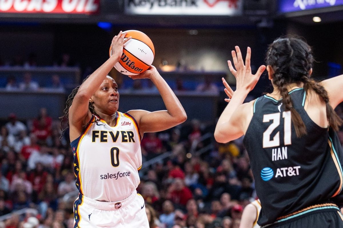 Aug 11, 2026; Indianapolis, Indiana, USA;  Indiana Fever guard Kelsey Mitchell (0) shoots the ball while New York Liberty center Han Xu (21) defends in the second half at Gainbridge Fieldhouse. Mandatory Credit: Trevor Ruszkowski-Imagn Images