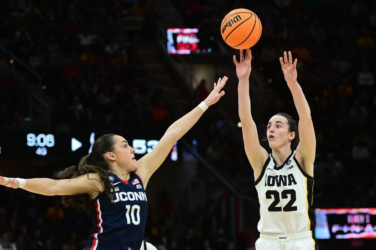 Apr 5, 2024; Cleveland, OH, USA; Iowa Hawkeyes guard Caitlin Clark (22) shoots the ball against Connecticut Huskies guard Nika Muhl (10) in the semifinals of the Final Four of the womens 2024 NCAA Tournament at Rocket Mortgage FieldHouse.