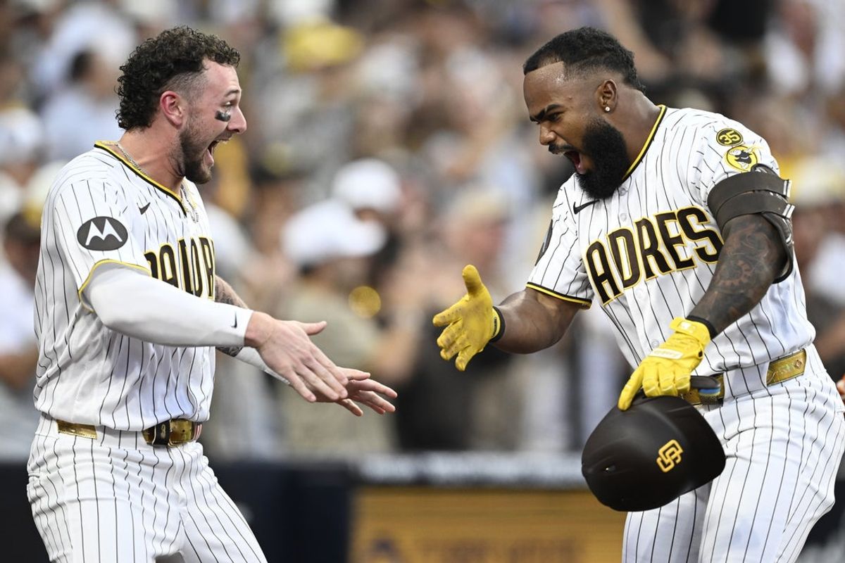 Aug 11, 2026; San Diego, California, USA; San Diego Padres designated hitter Luis Rengifo (21) celebrates with center fielder Jackson Merrill (3) after hitting a grand slam during the second inning against the Milwaukee Brewers at Petco Park. Mandatory Credit: Denis Poroy-Imagn Images