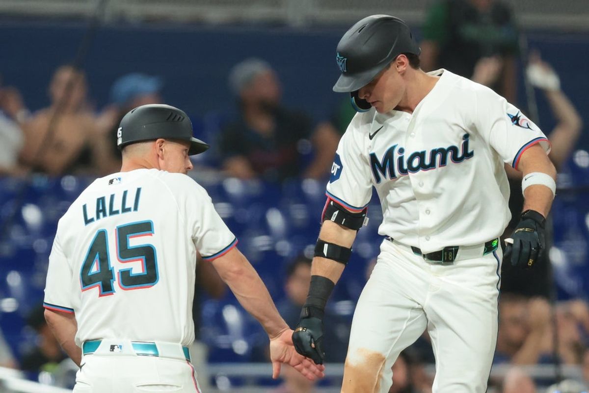 Aug 12, 2026; Miami, Florida, USA; Miami Marlins right fielder Griffin Conine (18) celebrates with third base coach Blake Lalli (45) after hitting a home run against the Pittsburgh Pirates during the fourth inning at loanDepot Park. Mandatory Credit: Sam Navarro-Imagn Images
