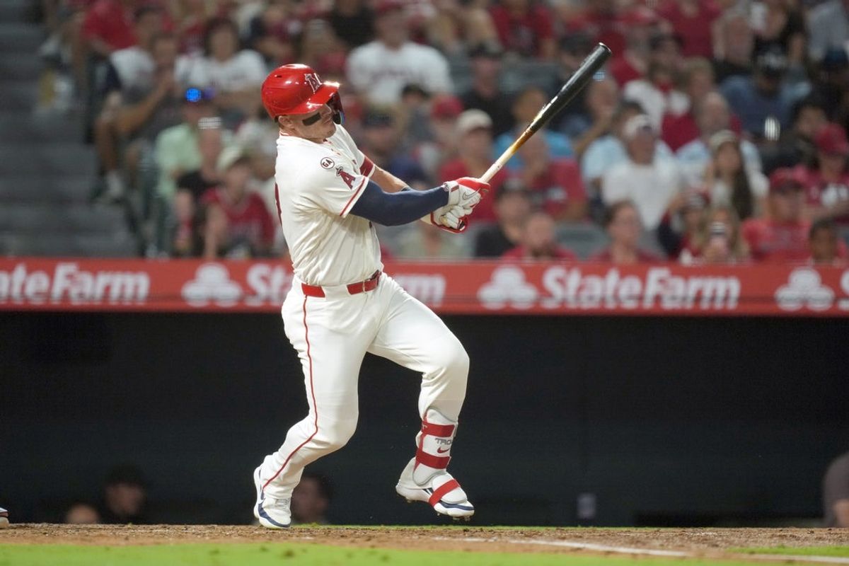 Aug 12, 2026; Anaheim, California, USA; Los Angeles Angels center fielder Mike Trout (27) hits a RBI single in the third inning against the Texas Rangers at Angel Stadium. Mandatory Credit: Kirby Lee-Imagn Images