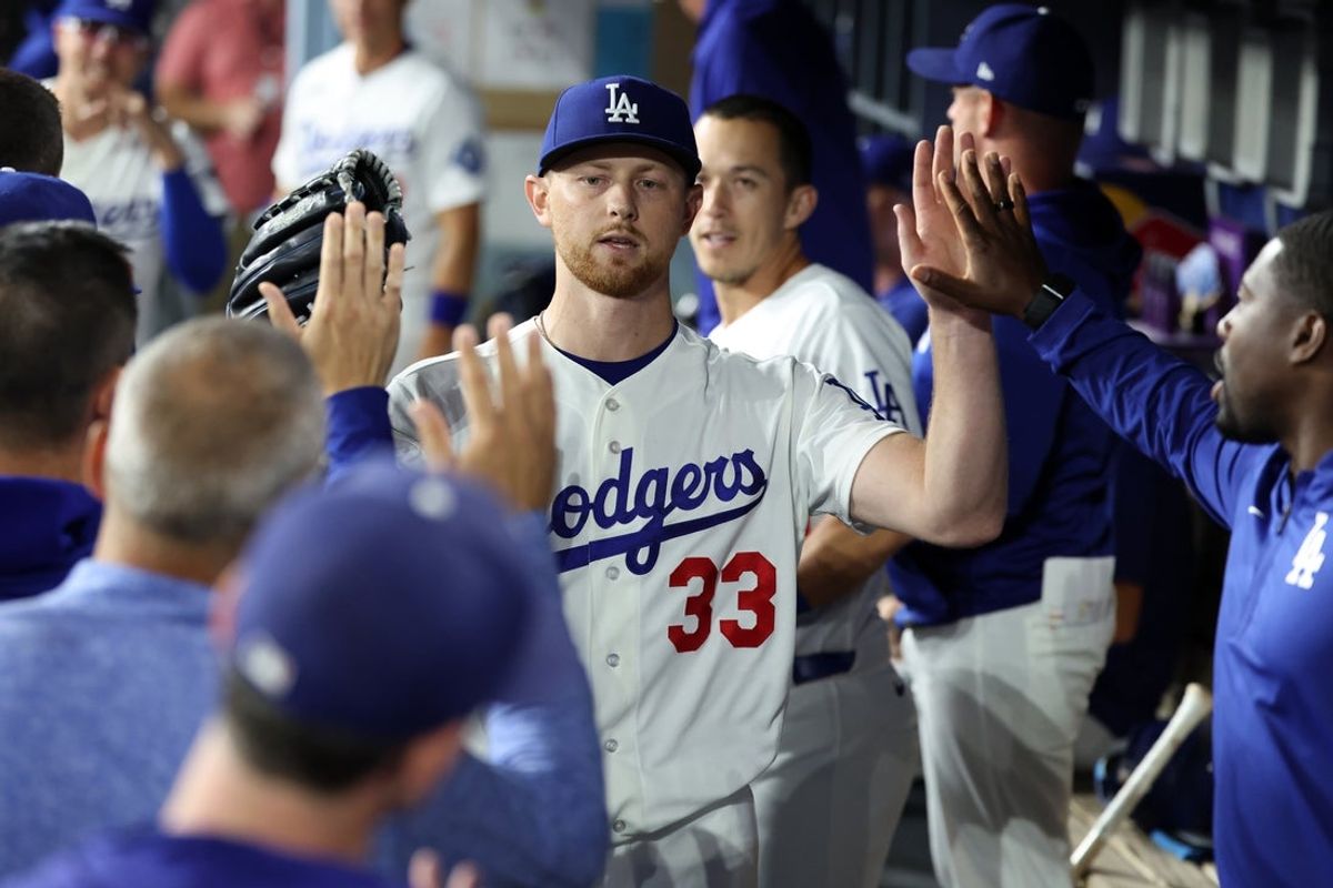 Aug 12, 2026; Los Angeles, California, USA;  Los Angeles Dodgers pitcher Eric Lauer (33) is greeted in the dugout after being removed from the game during the seventh inning against the Kansas City Royals at Dodger Stadium. Mandatory Credit: Kiyoshi Mio-Imagn Images