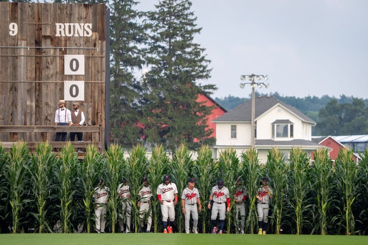 Players walk onto the field before a baseball game between the Minnesota Twins and Philadelphia Phillies at the Field of Dreams movie site, Thursday, Aug. 13, 2026, in Dyersville, Iowa.