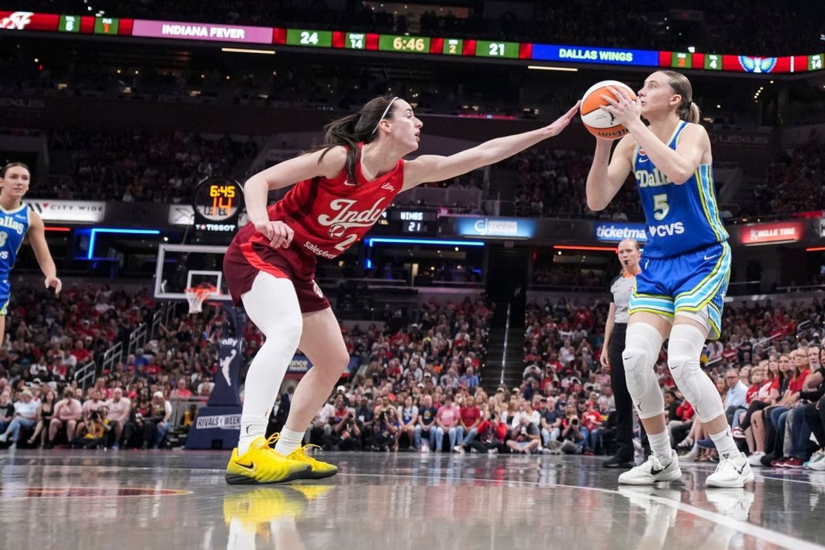 Dallas Wings guard Paige Bueckers (5) attempts a basket against Indiana Fever guard Caitlin Clark (22) on Friday, Aug. 14, 2026, during the first half of a game at Gainbridge Fieldhouse in Indianapolis.