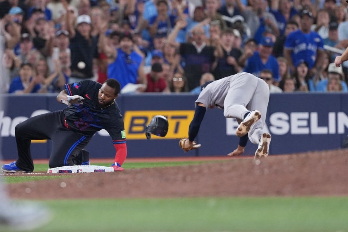 Aug 14, 2026; Toronto, Ontario, CAN; Toronto Blue Jays first baseman Vladimir Guerrero Jr. runs into New York Yankees shortstop George Lombard Jr. (96) during the sixth inning at Rogers Centre. Mandatory Credit: Nick Turchiaro-Imagn Images