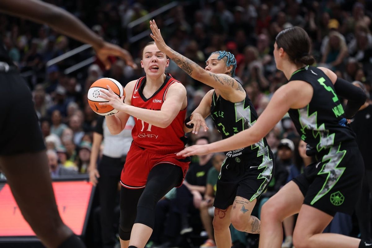 Aug 14, 2026; Seattle, Washington, USA; Portland Fire guard Holly Winterburn (77) controls the ball against the Seattle Storm in the fourth quarter at Climate Pledge Arena. Mandatory Credit: Richard Dizon-Imagn Images
