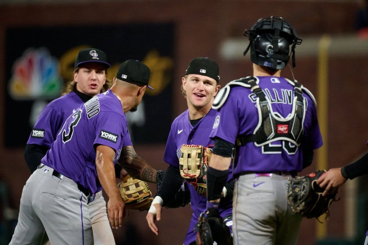 Aug 14, 2026; San Francisco, California, USA; Colorado Rockies outfielder Cole Carrigg (16) celebrates with catcher Brett Sullivan (26) and pitcher Brennan Bernardino (83) after defeating the against the San Francisco Giants in the ninth inning at Oracle Park. Mandatory Credit: Robert Edwards-Imagn Images