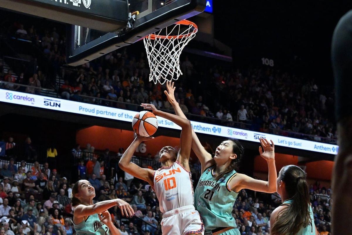 August 15, 2026; Uncasville, Connecticut, USA; Connecticut Sun center Olivia Nelson-Ododa (10) shoots a layup against New York Liberty center Han Xu (21) during the first half at Mohegan Sun Arena. Mandatory Credit: Eric Canha-Imagn Images
