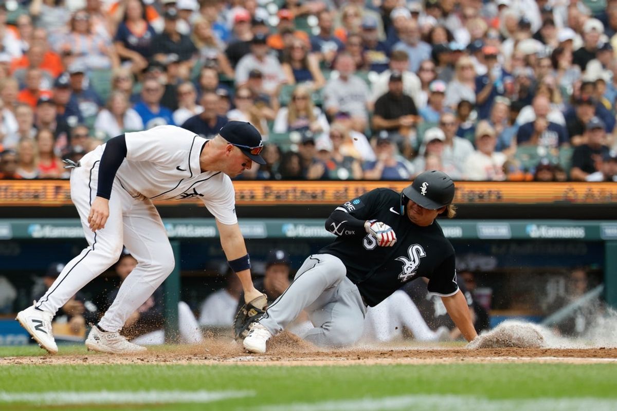 Aug 15, 2026; Detroit, Michigan, USA;  Chicago White Sox first baseman Munetaka Murakami (5) is tagged out at home by Detroit Tigers first baseman Spencer Torkelson (20) in the third inning at Comerica Park. Mandatory Credit: Rick Osentoski-Imagn Images