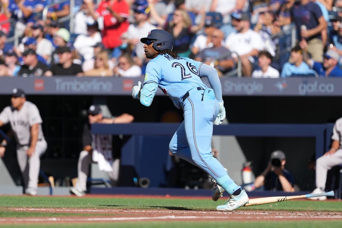 Aug 15, 2026; Toronto, Ontario, CAN;  Toronto Blue Jays first baseman Charles McAdoo (26) hits an RBI double against the New York Yankees during the seventh inning at Rogers Centre. Mandatory Credit: Nick Turchiaro-Imagn Images