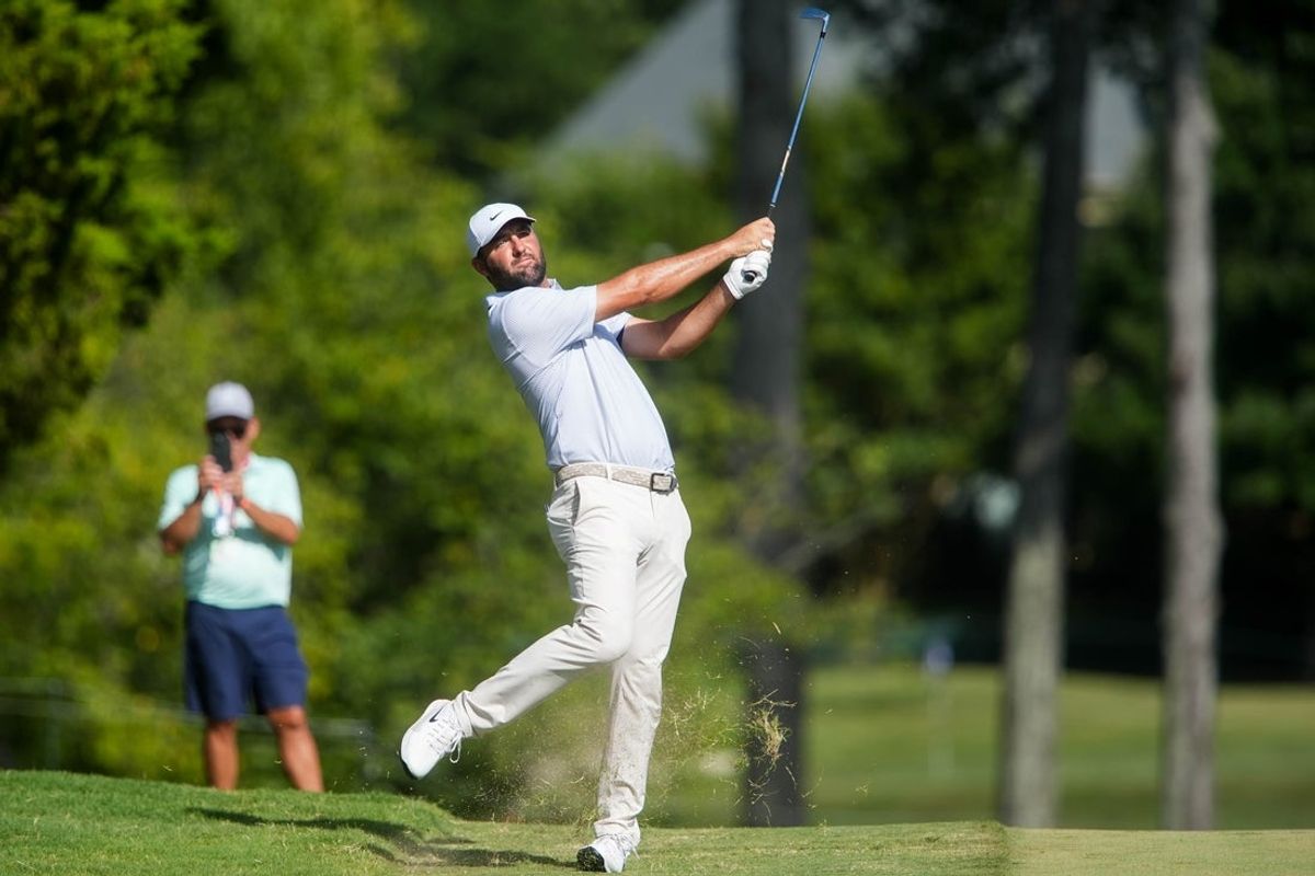 Scottie Scheffler hits an approach shot on the 16th hole during the third round of the FedEx St. Jude Championship at TPC Southwind in Memphis, Tenn., on August 15, 2026.