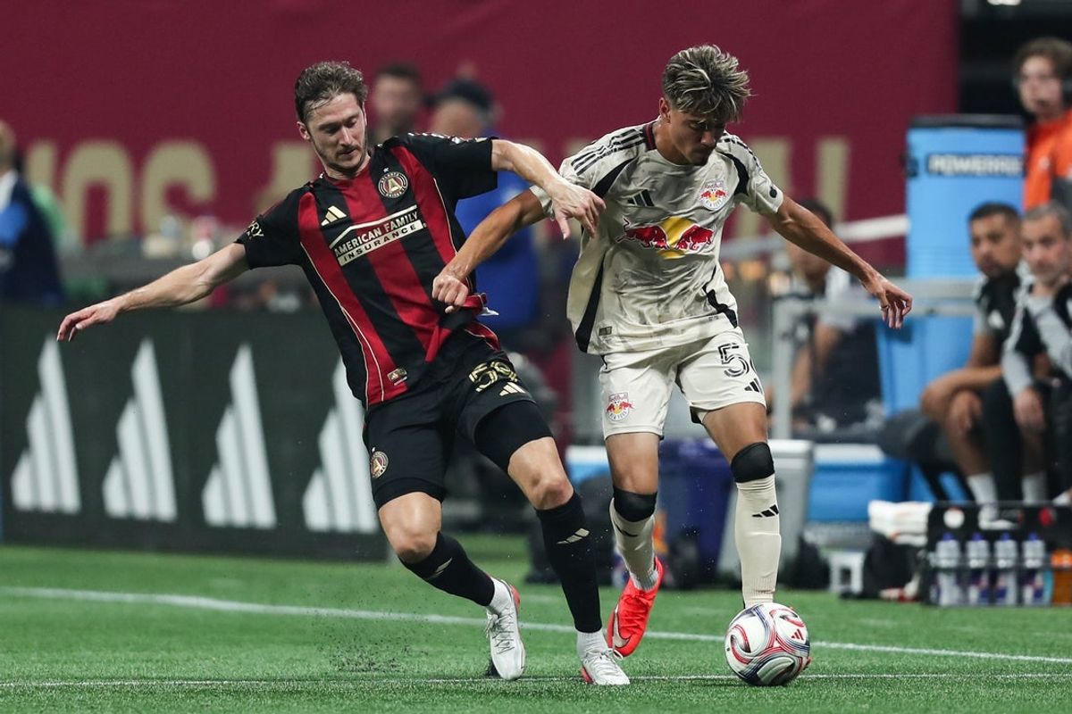 Aug 15, 2026; Atlanta, Georgia, USA; Atlanta United midfield Alexey Miranchuk (59) and Red Bull New York defense Matthew Dos Santos (56) battle for the ball in the first half at Mercedes-Benz Stadium. Mandatory Credit: Mady Mertens-Imagn Images