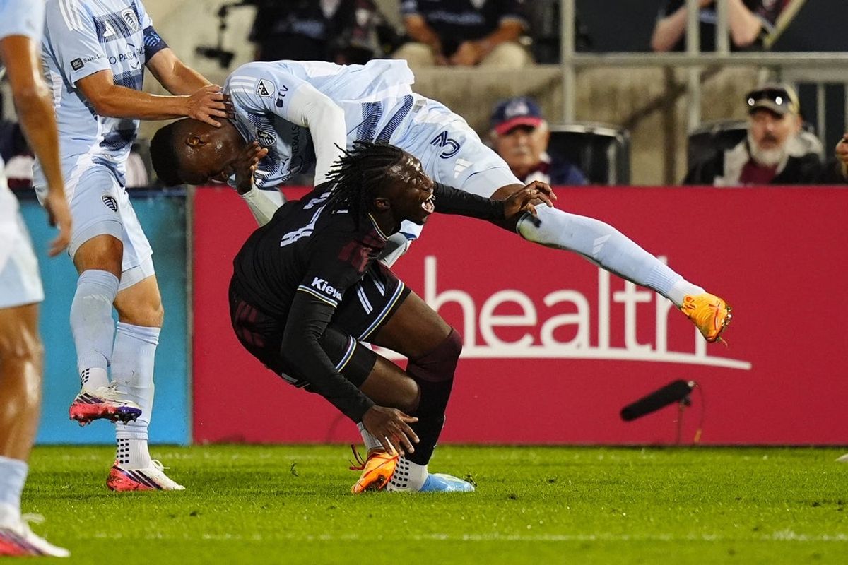 Aug 15, 2026; Commerce City, Colorado, USA; Sporting Kansas City defense Moisés Mosquera (3) collides into Colorado Rapids offense Darren Yapi (77) in the second half at Dick's Sporting Goods Park. Mandatory Credit: Ron Chenoy-Imagn Images