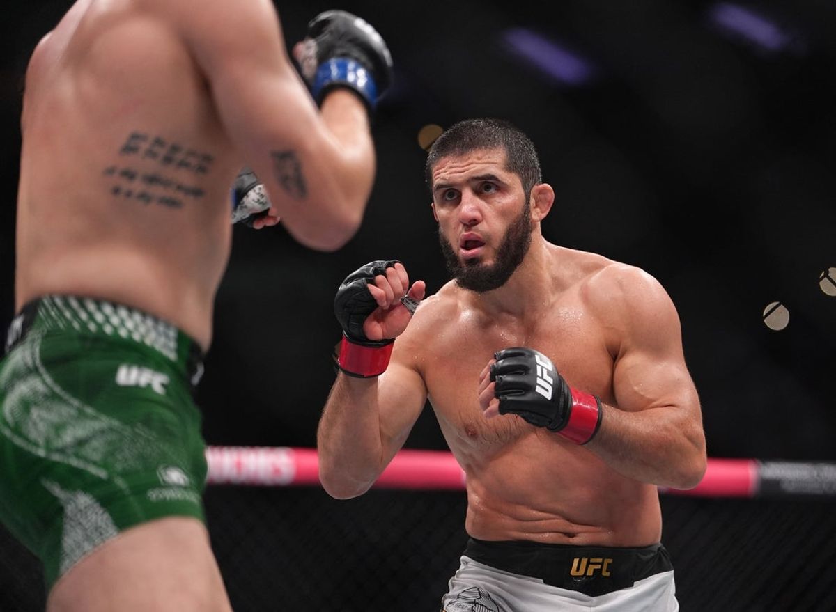 Aug 15, 2026; Philadelphia, Pennsylvania, USA; Islam Makhachev (red gloves) fights against Iah Machado Garry (blue gloves) in the welterweight title bout during UFC 330 at Xfinity Mobile Arena. Mandatory Credit: Kyle Ross-Imagn Images