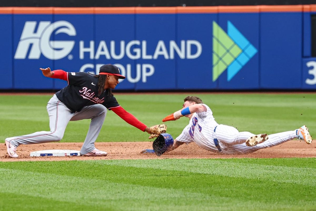 Aug 16, 2026; New York City, New York, USA;  New York Mets center fielder A.J. Ewing (9) is tagged out attempting to steal second base by Washington Nationals shortstop CJ Abrams (5) during the third inning at Citi Field. Mandatory Credit: Vincent Carchietta-Imagn Images