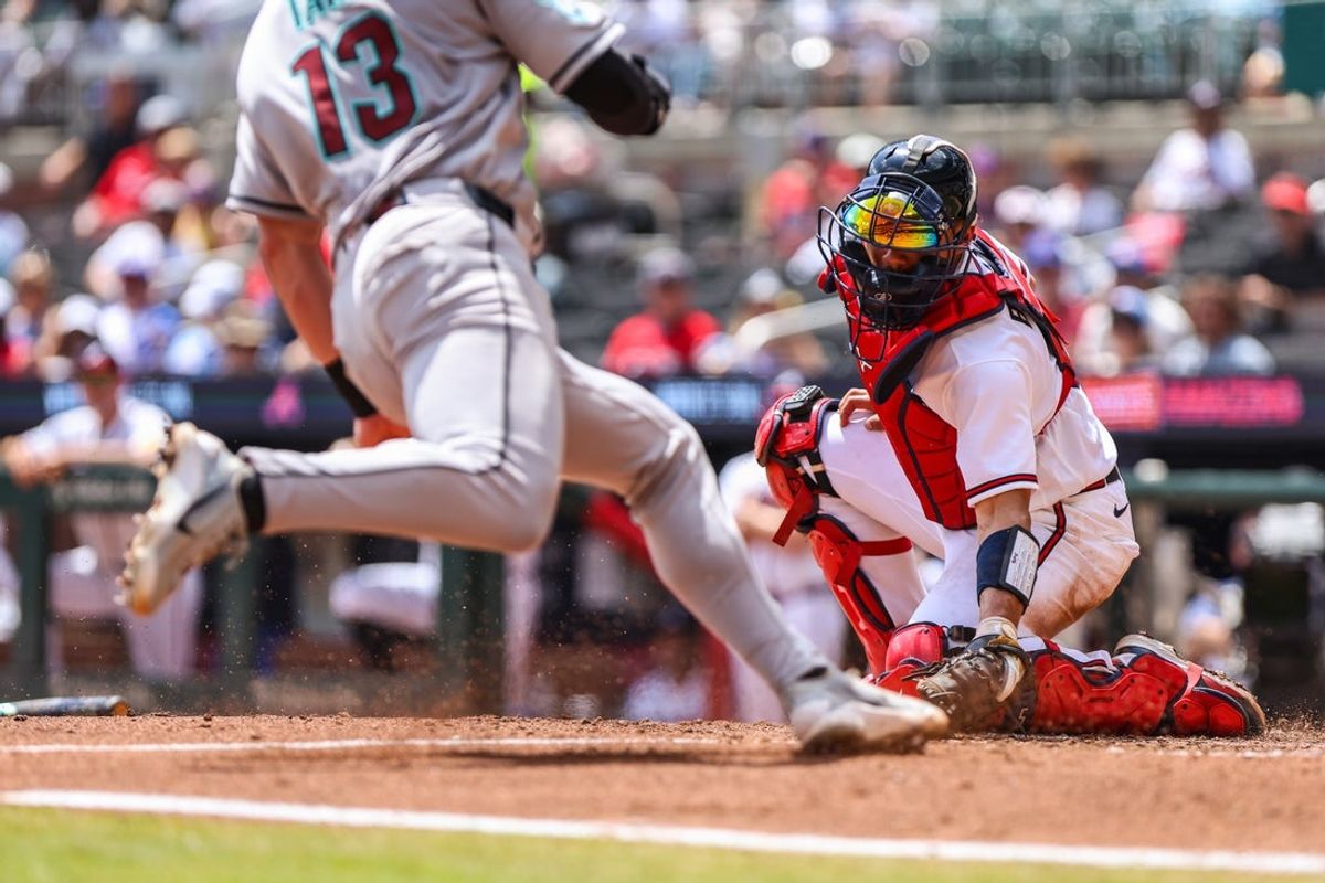 Aug 16, 2026; Cumberland, Georgia, USA; Atlanta Braves catcher Drake Baldwin (30) tags home plate for an out against Arizona Diamondbacks left fielder Tim Tawa (13) during the fifth inning at Truist Park. Mandatory Credit: Jordan Godfree-Imagn Images