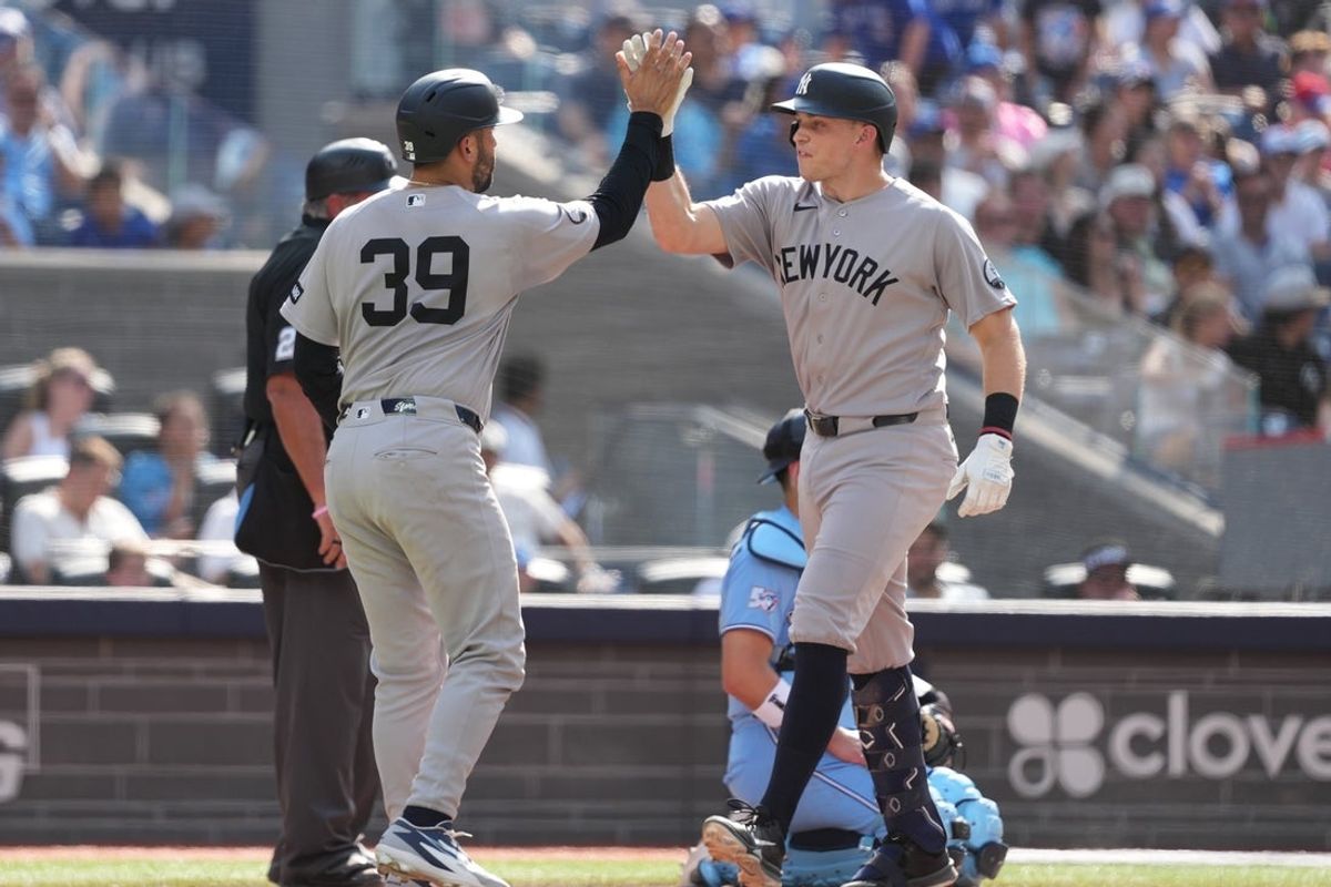 Aug 16, 2026; Toronto, Ontario, CAN; New York Yankees first baseman Ben Rice (22) hits a two run home run and celebrates with catcher Ali Sanchez (39) against the Toronto Blue Jays during the tenth inning at Rogers Centre. Mandatory Credit: Nick Turchiaro-Imagn Images
