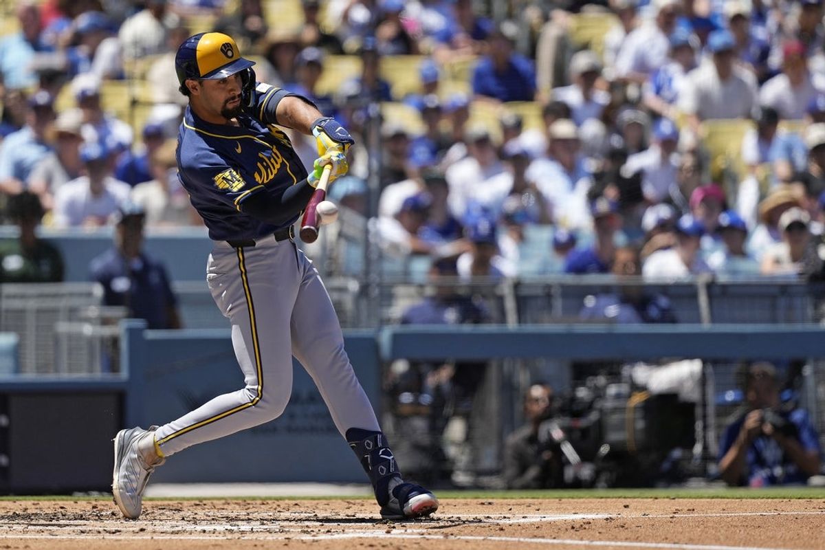 Aug 16, 2026; Los Angeles, California, USA;  Milwaukee Brewers shortstop Jonathan Ornelas (13) hits a single against the Los Angeles Dodgers in the first inning at Dodger Stadium. Mandatory Credit: Jon Endow-Imagn Images