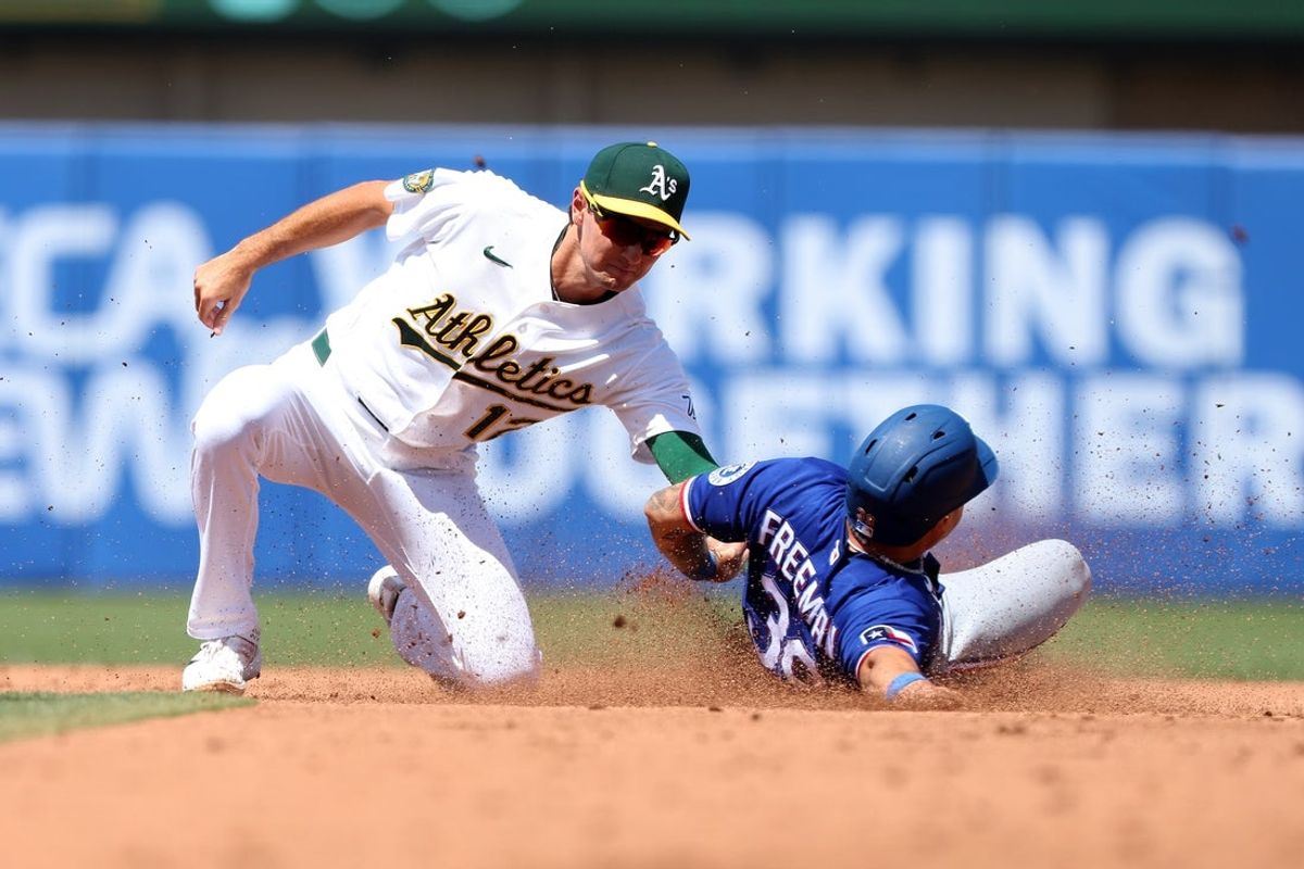 Aug 16, 2026; West Sacramento, California, USA; Athletics second baseman Alika Williams (12) tags out Texas Rangers left fielder Wyatt Langford (36) during the fourth inning at Sutter Health Park. Mandatory Credit: Dennis Lee-Imagn Images