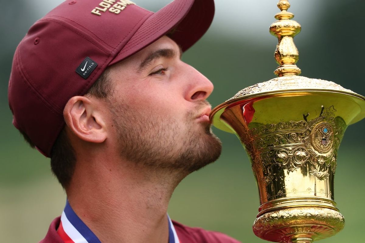 Aug 16, 2026; Ardmore, Pennsylvania, USA; Jack Whaley kisses the Havemeyer Trophy after winning the US Amateur Championship golf tournament at Merion Golf Club. Mandatory Credit: Bill Streicher-Imagn Images